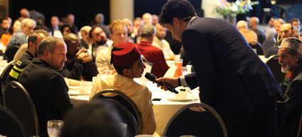 De spreker vraagt iets aan iemand aan tafel