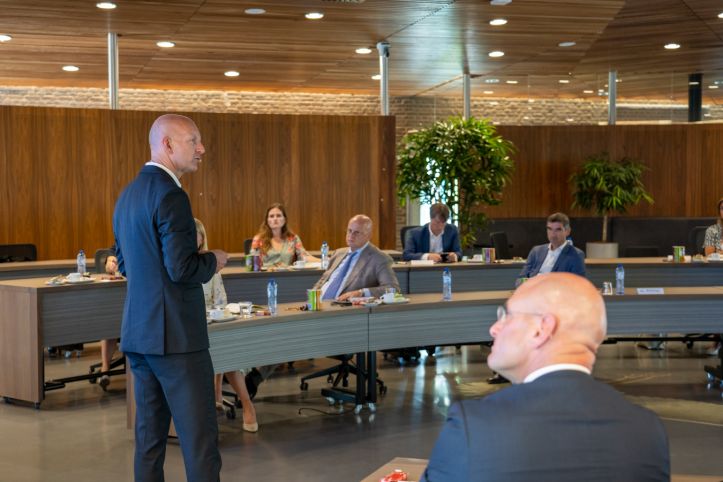 Projectleider spreekt groep toe, met in beeld Burgemeester Nieuwenburg, Minister Grapperhaus en staatssecretaris Blokhuis